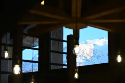 a view of a mountain through a window at Chalet Montana in Combloux