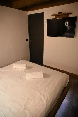 a bedroom with a bed with two towels on it at Chalet Montana in Combloux