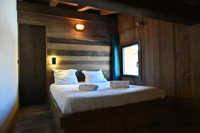 a bedroom with a bed with two pillows on it at Chalet Montana in Combloux