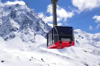 a ski lift in front of a snow covered mountain at Green Apple Chamonix, centre, parking, ski-in/out in Chamonix-Mont-Blanc