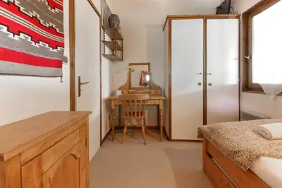 a bedroom with a desk and a table with a chair at Les Terrasses de Planpraz - 8min Walk to Center - Quiet - Perfect for Hiking in Chamonix-Mont-Blanc