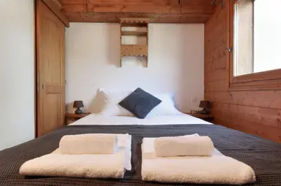 a bedroom with a bed with two pillows on it at Albertine - Centre de Chamonix - Garage - Mountain Views! in Chamonix-Mont-Blanc