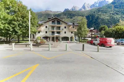 an empty parking lot in front of a building at Albertine - Centre de Chamonix - Garage - Mountain Views! in Chamonix-Mont-Blanc