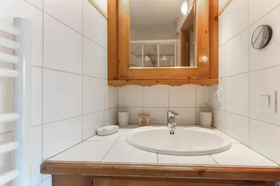 a bathroom with a sink and a mirror at Albertine - Centre de Chamonix - Garage - Mountain Views! in Chamonix-Mont-Blanc