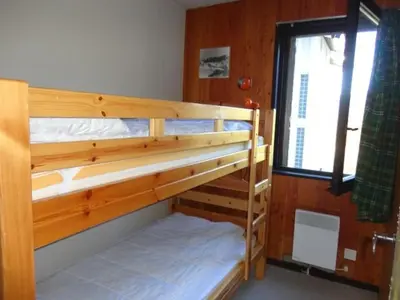 two bunk beds in a room with a window at 3P 6 Pers, Cuisine rénovée, Balcon Sud, Proche Pistes et Commerces, Parking, Casier à skis - FR-1-572-204 in Arâches-la-Frasse