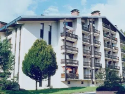 a large apartment building with balconies and a tree at 3P 6 Pers, Cuisine rénovée, Balcon Sud, Proche Pistes et Commerces, Parking, Casier à skis - FR-1-572-204 in Arâches-la-Frasse