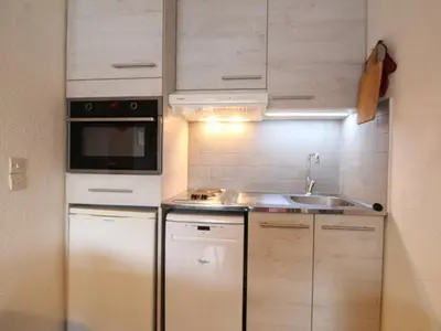 a kitchen with white cabinets and a sink and a microwave at 3P 6 Pers, Cuisine rénovée, Balcon Sud, Proche Pistes et Commerces, Parking, Casier à skis - FR-1-572-204 in Arâches-la-Frasse