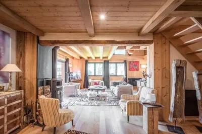 a large living room with wooden walls and ceilings at L'écrin des Bossons in Chamonix-Mont-Blanc