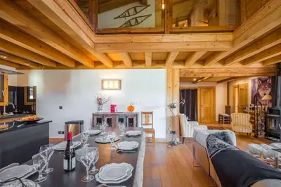 a living room with a table with wine glasses on it at L'écrin des Bossons in Chamonix-Mont-Blanc