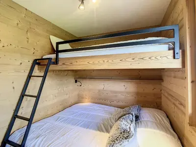 a room with two bunk beds and a ladder at Charmant 2P à Combloux avec terrasse, parking et casier à ski - FR-1-560-101 in Combloux