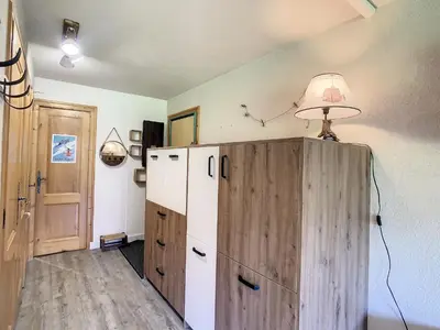 a kitchen with a refrigerator and a lamp on top at Charmant 2P à Combloux avec terrasse, parking et casier à ski - FR-1-560-101 in Combloux