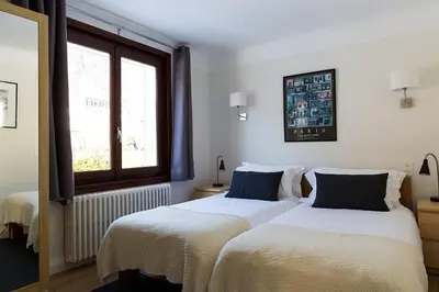 a bedroom with two beds and a window at Chalet Chintalaya in Chamonix-Mont-Blanc
