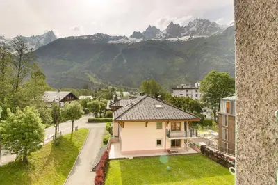 a bedroom with two beds and a window at Maison Emile Devouassoud in Chamonix-Mont-Blanc