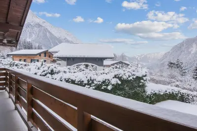 a snow covered balcony with a view of a mountain at Chalet Bossons - Welkeys in Chamonix-Mont-Blanc