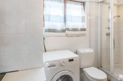 a bathroom with a washing machine and a toilet at Chalet Bossons - Welkeys in Chamonix-Mont-Blanc