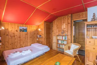 a bedroom with a bed in a room with wooden walls at Chalet Bossons - Welkeys in Chamonix-Mont-Blanc