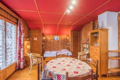 a dining room with a table and chairs in a room at Chalet Bossons - Welkeys in Chamonix-Mont-Blanc