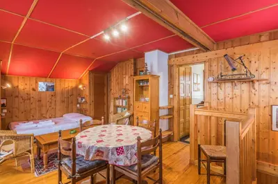 a dining room with a table and chairs and a bedroom at Chalet Bossons - Welkeys in Chamonix-Mont-Blanc