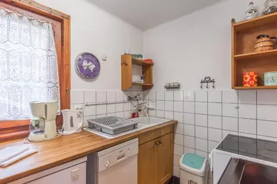 a kitchen with a counter top with a sink and a window at Chalet Bossons - Welkeys in Chamonix-Mont-Blanc