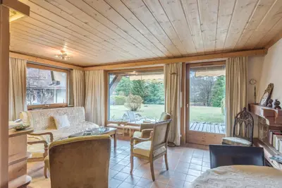 a living room with a couch and a table and chairs at Appartement Lanura - Welkeys in Megève