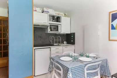 a kitchen with a table with a table cloth on it at Beau Glacier - Pied des Pistes - Balcons du Savoy in Chamonix-Mont-Blanc