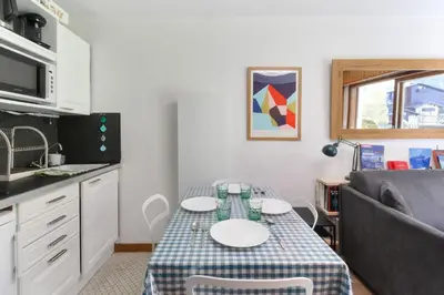 a small kitchen with a table and a couch at Beau Glacier - Pied des Pistes - Balcons du Savoy in Chamonix-Mont-Blanc