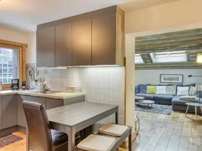a kitchen and living room with a table and a couch at Appartement lumineux 2 chambres proche centre, animaux admis, parking, WiFi - FR-1-453-296 in Megève