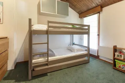 a bedroom with bunk beds in a room at Le Chamouny- Family Apt - Central - Quiet - Hikeing & Rock Climbing Close by in Chamonix-Mont-Blanc