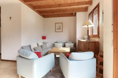 a living room with two couches and a table at Le Chamouny- Family Apt - Central - Quiet - Hikeing & Rock Climbing Close by in Chamonix-Mont-Blanc