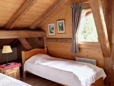 a bedroom with a bed in a log cabin at Chalet rénové 3 étoiles, 14 pers, vue Mont Blanc, Wifi - FR-1-560-102 in Cordon