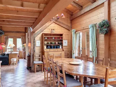 a dining room with a wooden table and chairs at Chalet rénové 3 étoiles, 14 pers, vue Mont Blanc, Wifi - FR-1-560-102 in Cordon