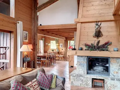 a living room with a fireplace in a log cabin at Chalet rénové 3 étoiles, 14 pers, vue Mont Blanc, Wifi - FR-1-560-102 in Cordon