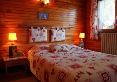 two bunk beds in a room with wooden walls at mlb22 in Les Carroz d'Araches
