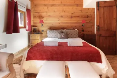 a bedroom with a large bed and wooden walls at Clos des Vorgeats - Duplex Beside Golf Course - Patio - UTMB in Chamonix-Mont-Blanc