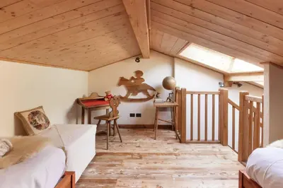 a room with wooden ceilings and a table and chairs at Clos des Vorgeats - Duplex Beside Golf Course - Patio - UTMB in Chamonix-Mont-Blanc