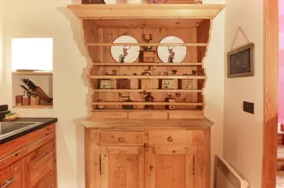 a kitchen with a wooden cabinet in a room at Clos des Vorgeats - Duplex Beside Golf Course - Patio - UTMB in Chamonix-Mont-Blanc