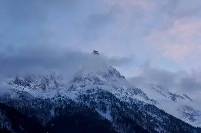 a mountain covered in snow and clouds on top of it at Modern 2BR 5* pool gym spa garage Mont-Blanc view in Chamonix-Mont-Blanc