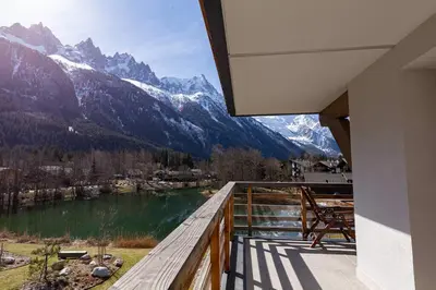 a balcony with a view of a lake and mountains at Modern 2BR 5* pool gym spa garage Mont-Blanc view in Chamonix-Mont-Blanc
