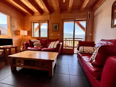 a living room with red couches and a coffee table at Chalet tradition 6 pers avec cheminée, balcon et parking à Samoëns - FR-1-624-124 in Samoëns