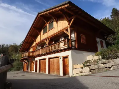 a large wooden house with a balcony on top of it at Chalet tradition 6 pers avec cheminée, balcon et parking à Samoëns - FR-1-624-124 in Samoëns