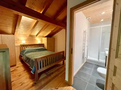 a bedroom with a bed and a bathroom at Chalet tradition 6 pers avec cheminée, balcon et parking à Samoëns - FR-1-624-124 in Samoëns