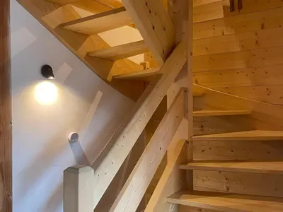 a spiral staircase in a wooden house with a light bulb at Chalet tradition 6 pers avec cheminée, balcon et parking à Samoëns - FR-1-624-124 in Samoëns