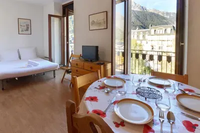a dining room with a table and a view of a building at Carlton - Center of Chamonix - Historic building in Chamonix-Mont-Blanc