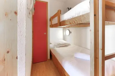 a room with two bunk beds and a red door at Carlton - Center of Chamonix - Historic building in Chamonix-Mont-Blanc