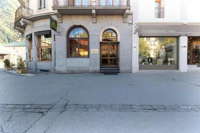 a store front of a building with glass doors at Carlton - Center of Chamonix - Historic building in Chamonix-Mont-Blanc