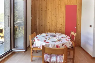 a dining room with a table and chairs and a window at Carlton - Center of Chamonix - Historic building in Chamonix-Mont-Blanc