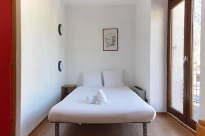 a white bed in a room with a window at Carlton - Center of Chamonix - Historic building in Chamonix-Mont-Blanc