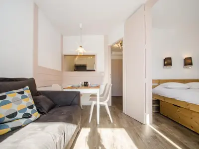 a living room with a couch and a bed and a desk at Appartement cosy à Chamonix Sud pour 4 pers, animaux acceptés - FR-1-343-157 in Chamonix-Mont-Blanc