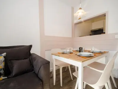 a dining room with a table and a couch at Appartement cosy à Chamonix Sud pour 4 pers, animaux acceptés - FR-1-343-157 in Chamonix-Mont-Blanc