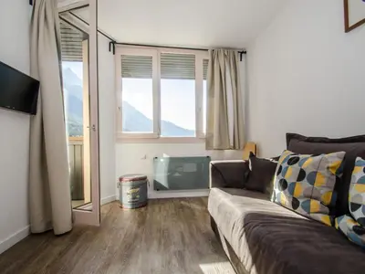a living room with a couch and a large window at Appartement cosy à Chamonix Sud pour 4 pers, animaux acceptés - FR-1-343-157 in Chamonix-Mont-Blanc